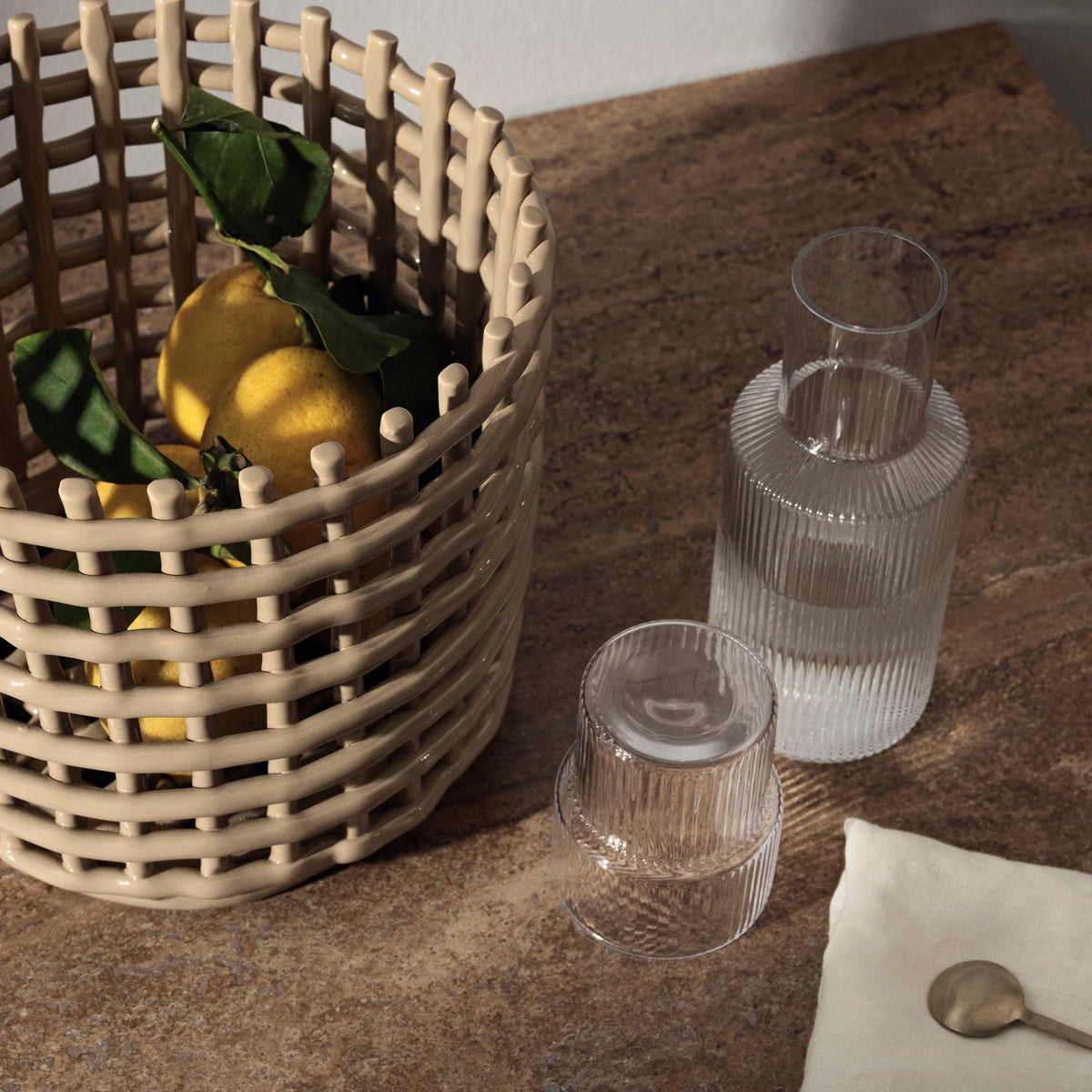 ferm Living Ripple Carafe Set - Small, Clear, beside a ceramic basket - KANSO#Color_Clear