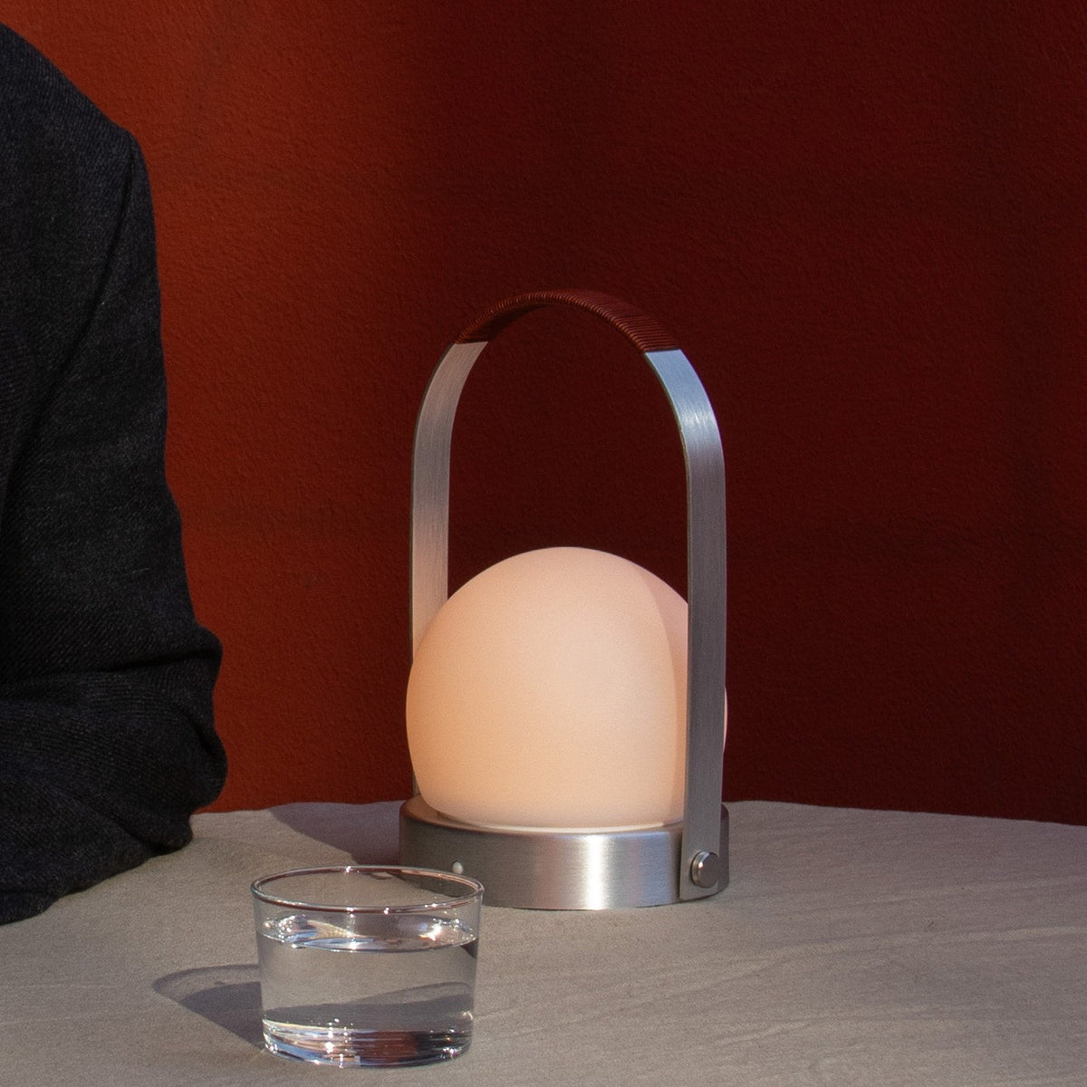 Audo Copenhagen Carrie LED Lamp Brushed Aluminium Leather lit on a dining table - KANSO#Color_Brushed Aluminium Leather
