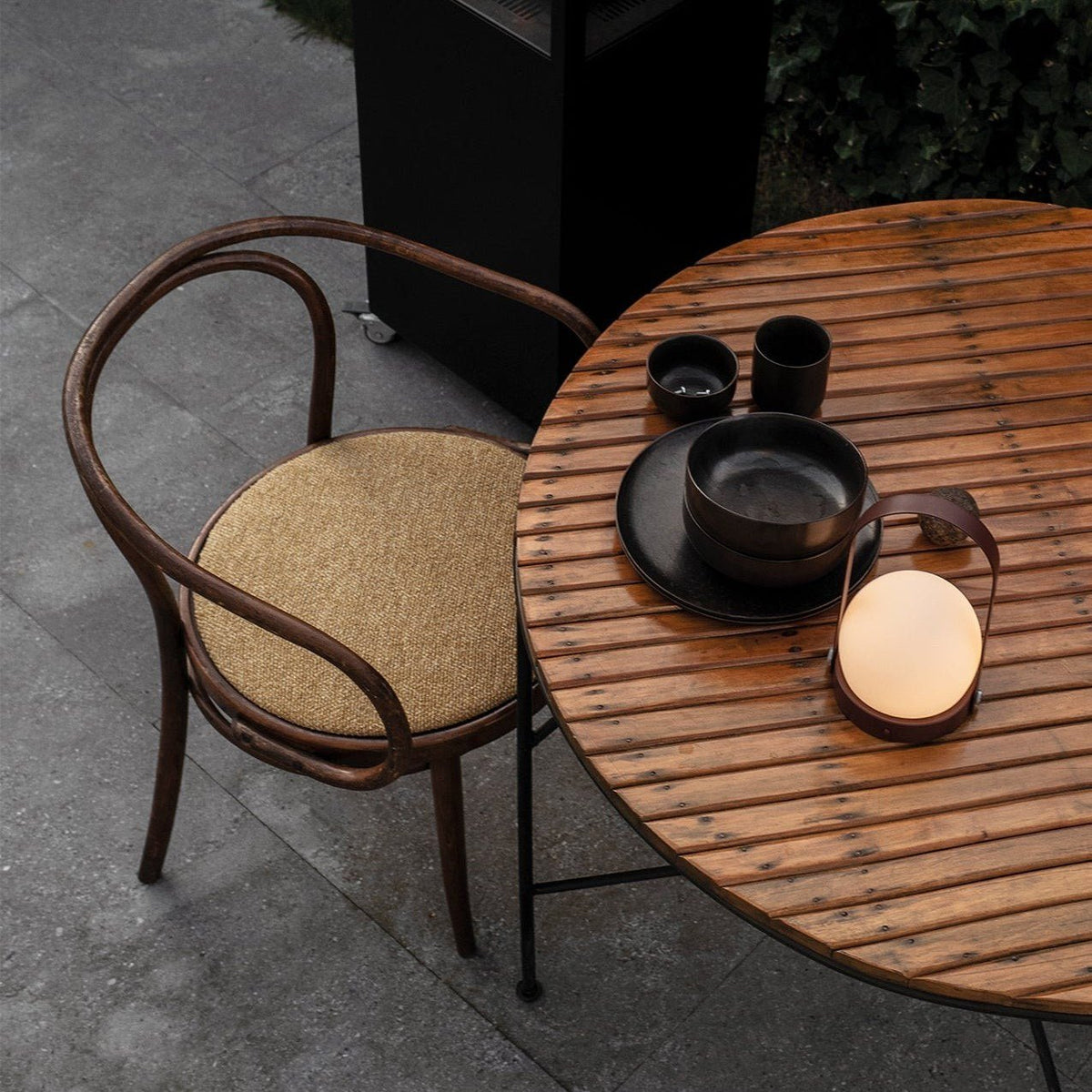 Audo Copenhagen Carrie LED Lamp Bronzed Brass on an outdoor dining table - KANSO#Color_Bronzed Brass