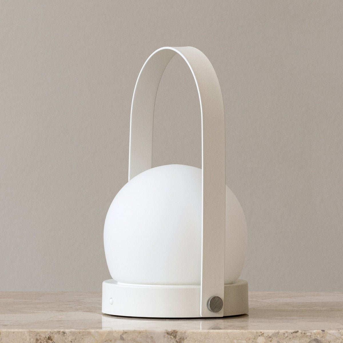 Audo Copenhagen Carrie LED Lamp White on a stone shelf - KANSO#Color_White