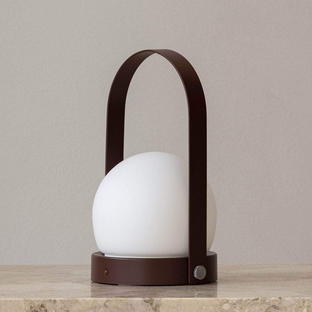 Audo Copenhagen Carrie LED Lamp Burned Red on a stone shelf - KANSO#Color_Burned Red