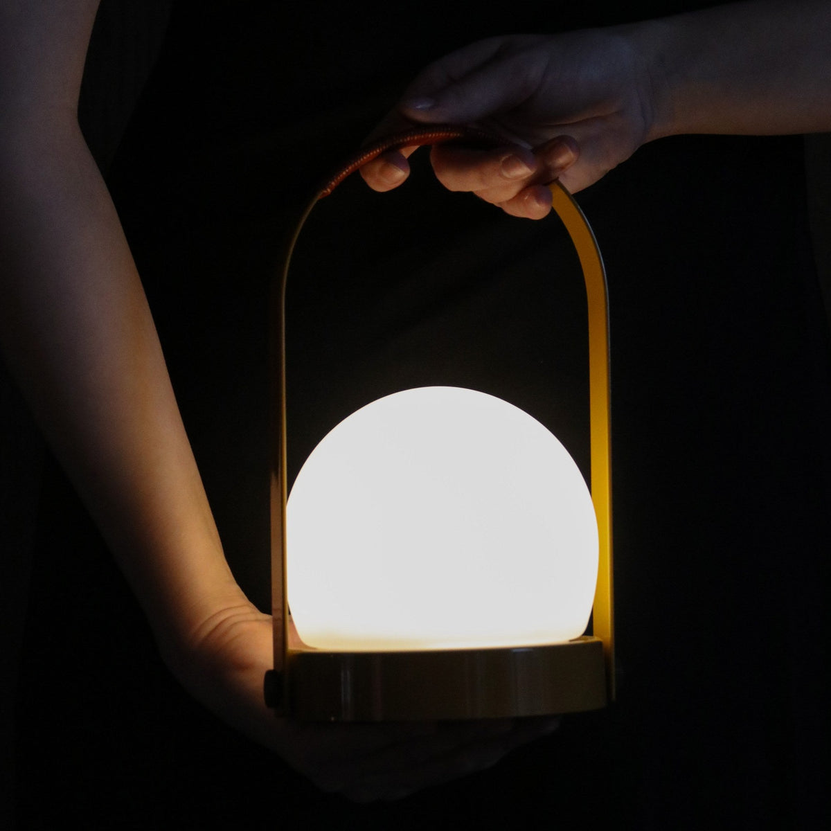 Audo Copenhagen Carrie LED Lamp Golden Brown Leather carried by the handle - KANSO#Color_Golden Brown Leather