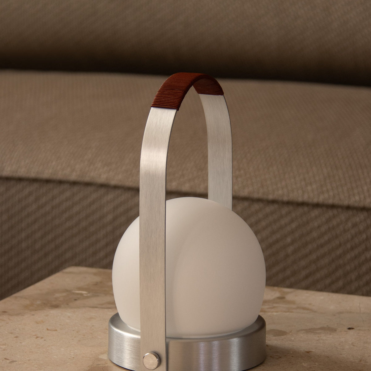 Audo Copenhagen Carrie LED Lamp Brushed Aluminium Leather on a stone coffee table - KANSO#Color_Brushed Aluminium Leather