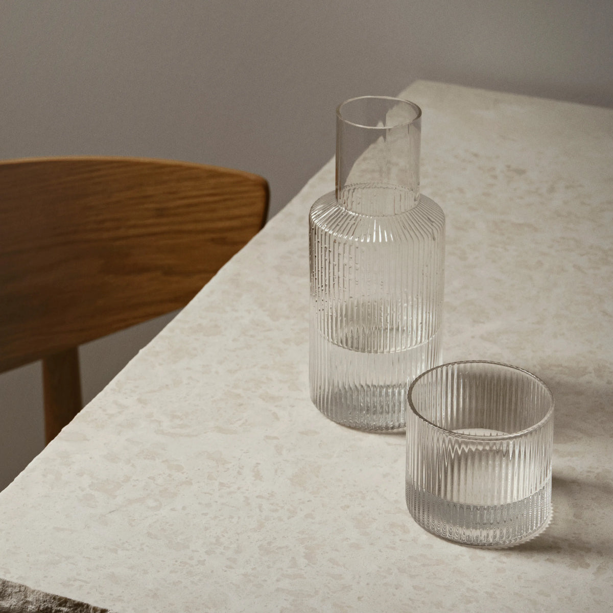 ferm Living Ripple Carafe Set - Small, Clear, on a stone table - KANSO#Color_Clear